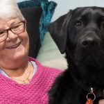 Close of a woman with her black labrador - Guide Dog Bella