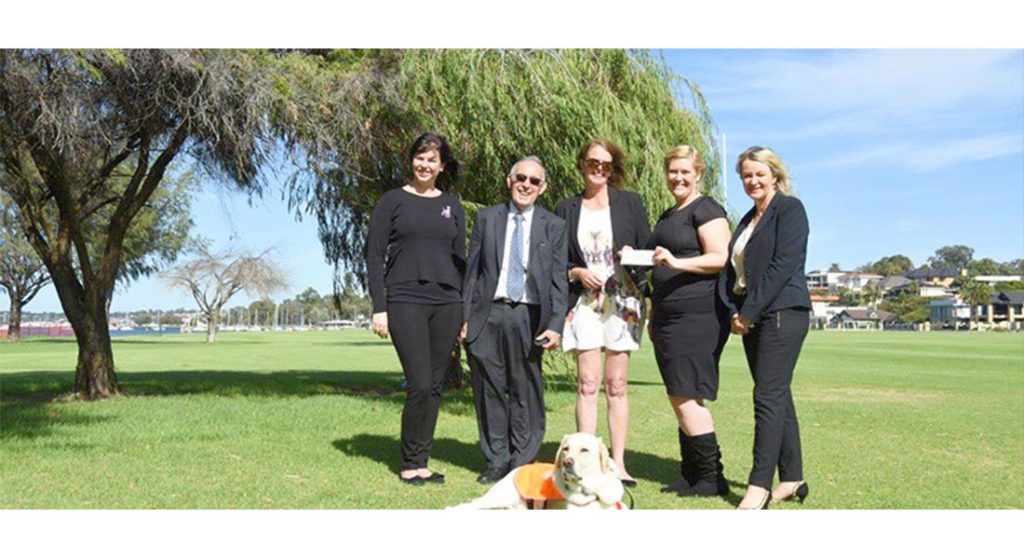 Attendees of memorial ceremony with Ambassador Dog Gidgee