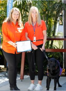 Chief Executive Officer Anna and Instructor Katie with Facility Dog Winston receiving his award. 